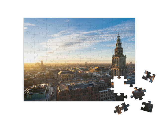 Puzzel 100 stukjes „De zonsondergang bij de Martinitoren en de historische binnenstad van Groningen“