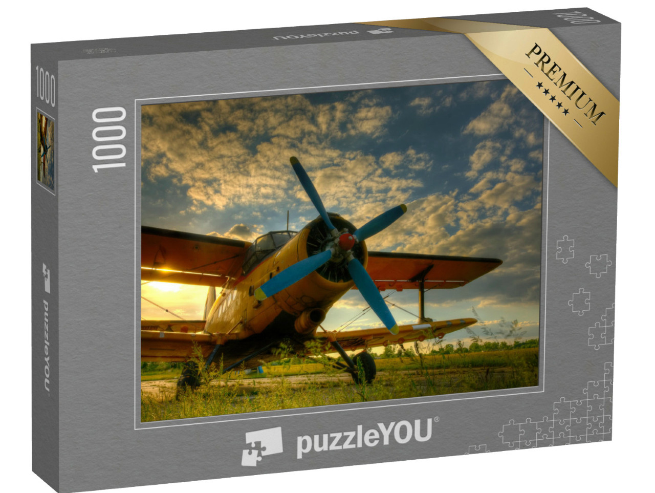 Puzzel 1000 stukjes „Historisch vliegtuig op groen gras bij zonsondergang“