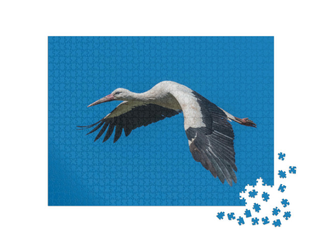 Puzzel 1000 stukjes „Vliegende witte ooievaar in de blauwe lucht“