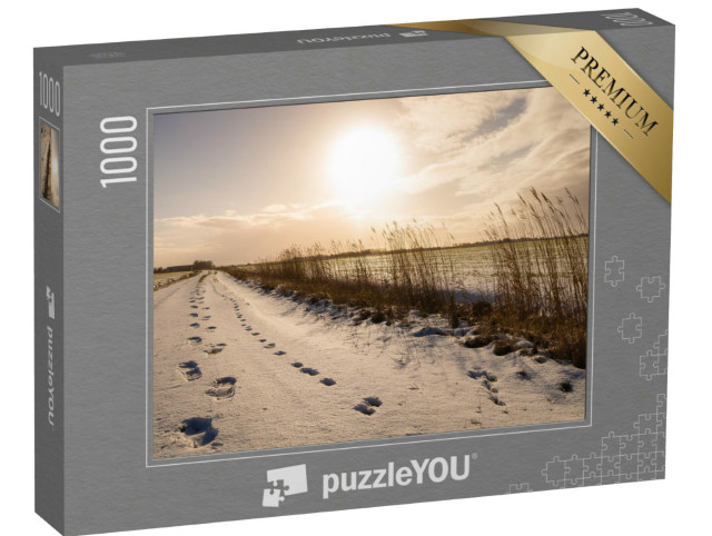 Puzzel 1000 stukjes „Voetafdrukken door de sneeuw, Oost-Friesland“