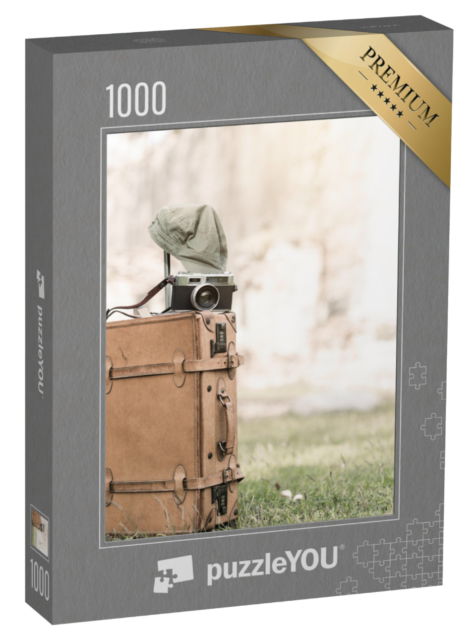 Puzzel 1000 stukjes „Vintage camera op een oude fietstas in het gras“