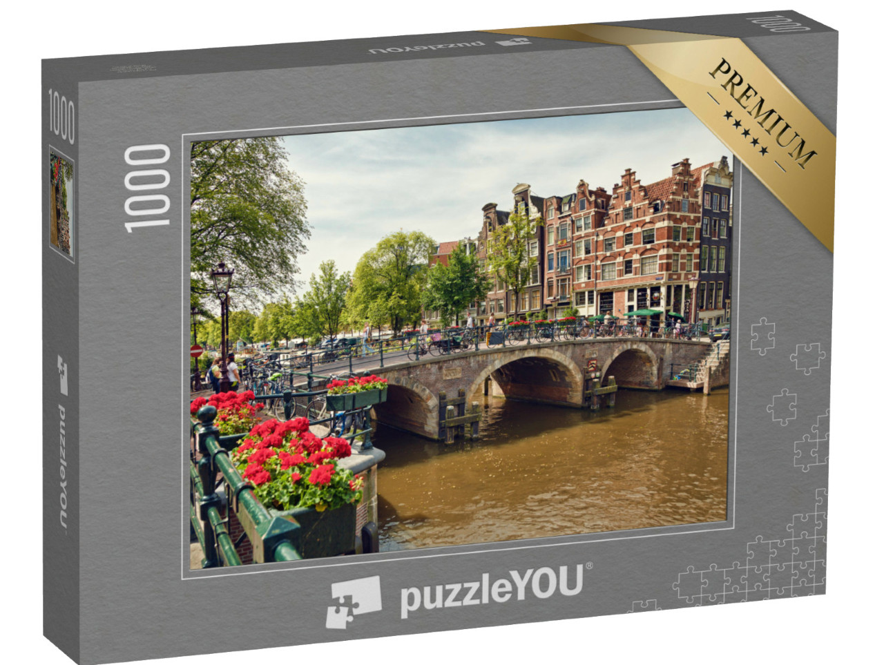 Puzzel 1000 stukjes „Drievoudige boogbrug in Amsterdam met geraniumbloesems tussen de grachten“