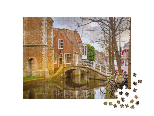Puzzel 1000 stukjes „Delft met traditionele Nederlandse huizen, brug en gracht in het stadscentrum“