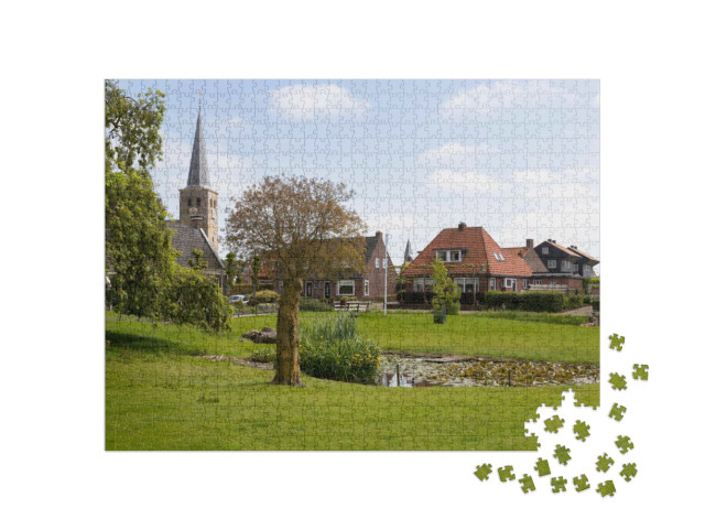 Puzzel 1000 stukjes „Dorpsgezicht met de torenspits van de Sint-Martinuskerk in het dorp Hallum“